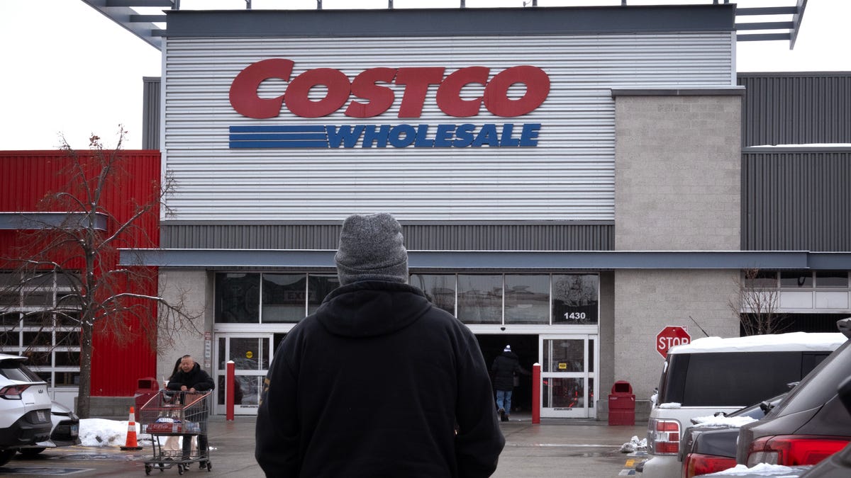 Customers walk in the parking lot outside a Costco store on December 02, 2025 in Chicago, Illinois.