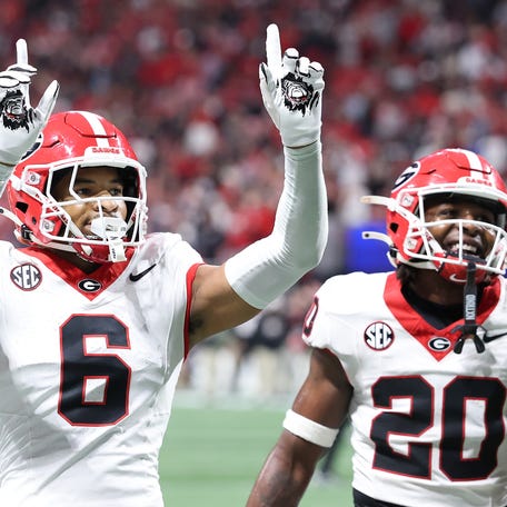 ATLANTA, GEORGIA - DECEMBER 06: Daylen Everette #6 and Jacorey Thomas #20 of the Georgia Bulldogs celebrate after a defensive stop against the Alabama Crimson Tide during the fourth quarter in the 2025 SEC Championship at Mercedes-Benz Stadium on December 06, 2025 in Atlanta, Georgia. (Photo by Kevin C. Cox/Getty Images)