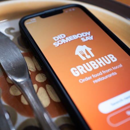 In this photo illustration, the app for Grubhub, a mobile food ordering and delivery service headquartered in Chicago, is shown on a cell phone on November 13, 2024, in Chicago, Illinois.