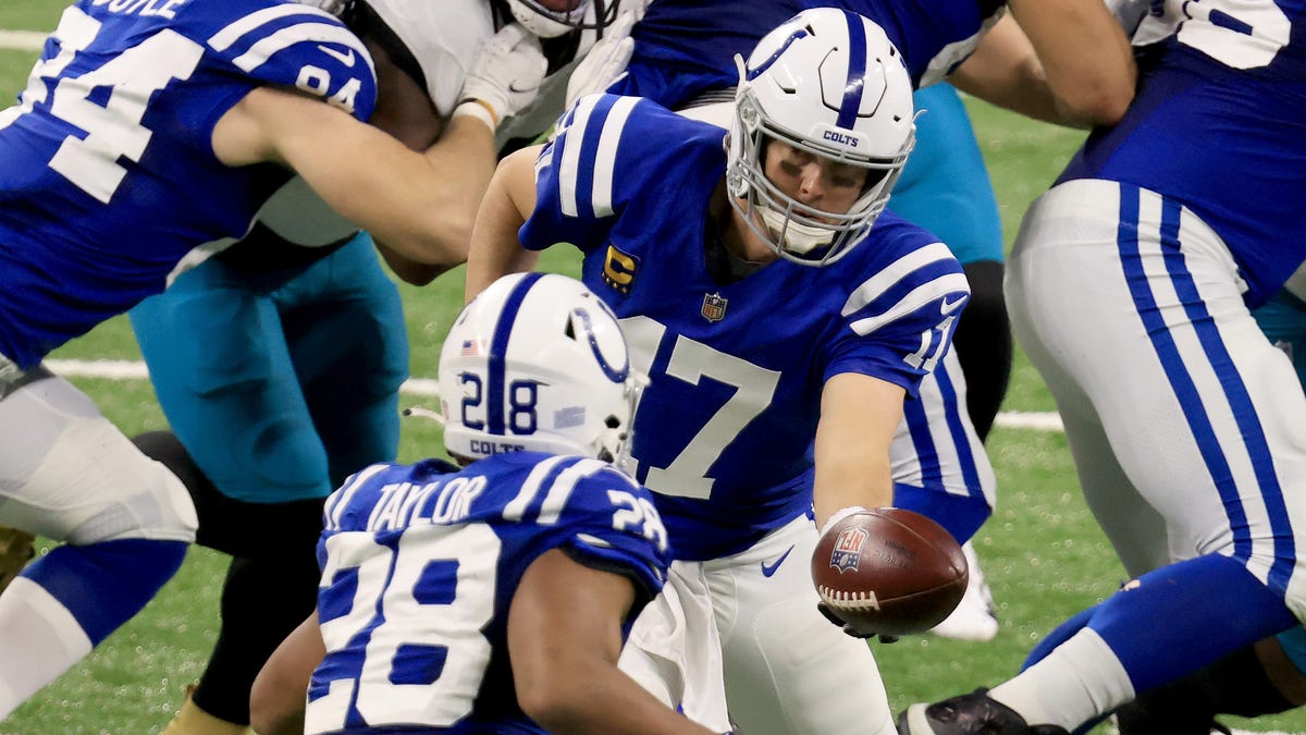 INDIANAPOLIS, INDIANA - JANUARY 03: Philip Rivers #17 of the Indianapolis Colts hands the ball off to Jonathan Taylor #28 during the second quarter of the game against the Jacksonville Jaguars at Lucas Oil Stadium on January 03, 2021 in Indianapolis, Indiana. (Photo by Justin Casterline/Getty Images)