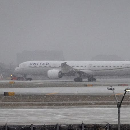 A jet taxis in snow at O'Hare International Airport on December 22, 2022, in Chicago. A winter weather system bringing snow, high winds, and sub-zero temperatures has wreaked havoc on holiday travel during one of the busiest days of the year for airlines.
