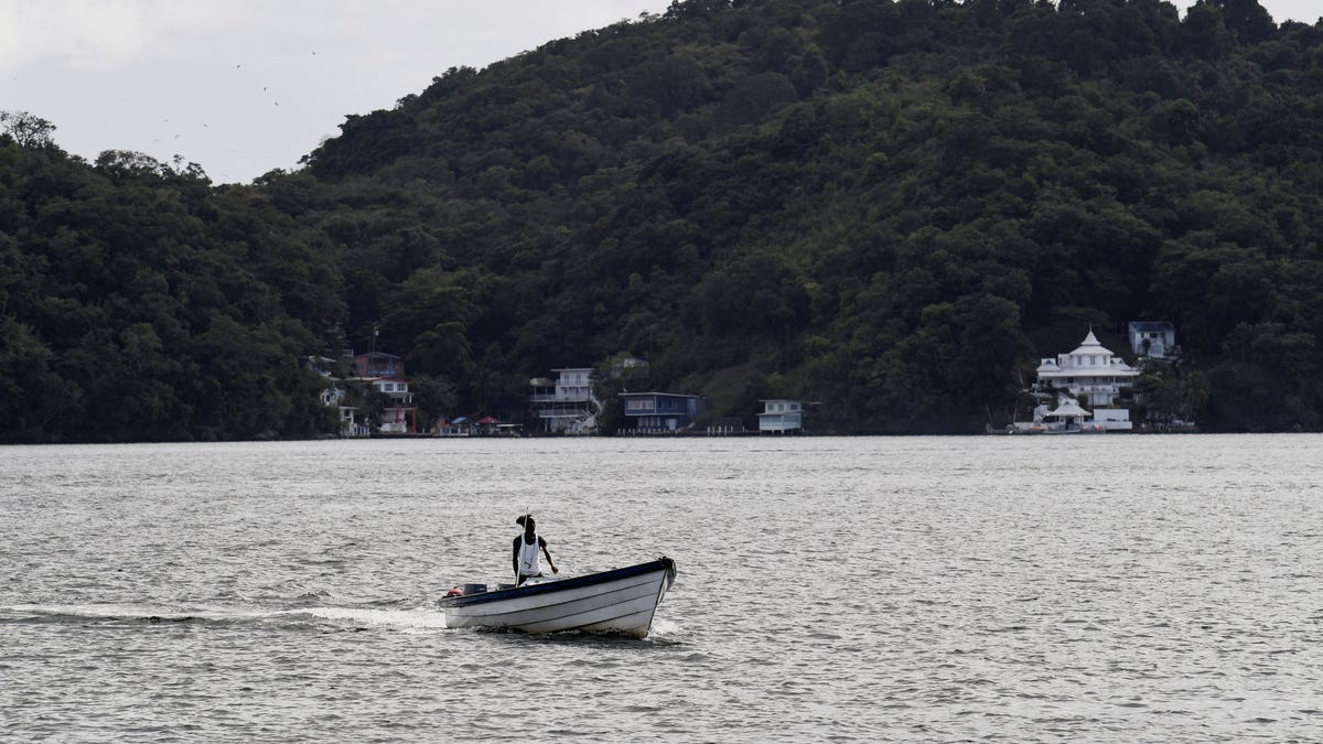 A taxi boat sails to pick up passengers on the shoreline of the Gulf of Paria, across from Venezuela, after U.S. President Donald Trump said on Saturday that the airspace above and surrounding Venezuela should be considered closed in its entirety, amid rising tensions between the administrations of Trump and Venezuela's President Nicolas Maduro, in Changuaramas, Trinidad and Tobago, November 29, 2025. REUTERS/Amanda Sabga