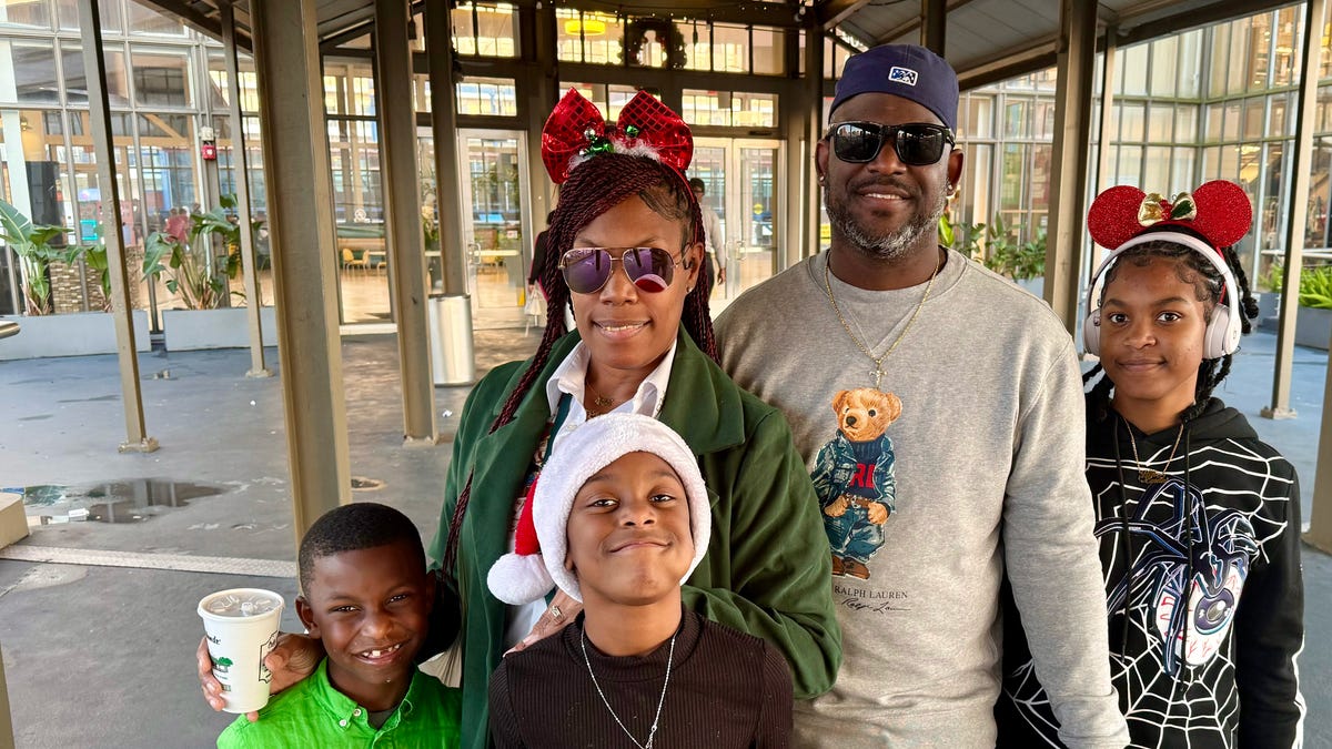 Chris and Shawnell Thiel stand with their kids outside the Riverwalk Outlets in New Orleans on Dec. 7, 2025, after watching the city's Christmas parade and doing a little holiday shopping.
