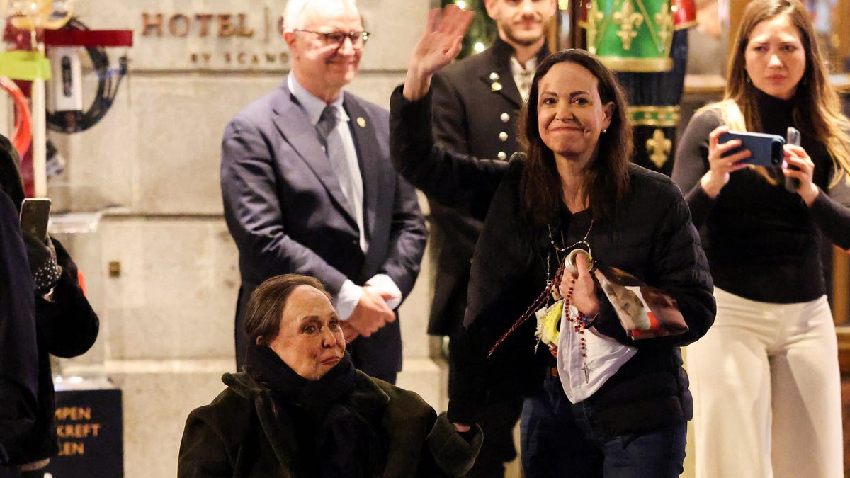 Nobel Peace Prize laureate Maria Corina Machado waves beside her mother outside the Grand Hotel in Oslo, Norway, on Dec. 11, 2025.