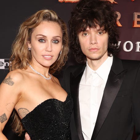 HOLLYWOOD, CALIFORNIA - DECEMBER 01: (L-R) Miley Cyrus and Maxx Morando attend the world premiere of 20th Century Studios "Avatar: Fire and Ash" at The Dolby Theatre in Hollywood, California on December 01, 2025. (Photo by Jesse Grant/Getty Images for 20th Century Studios)
