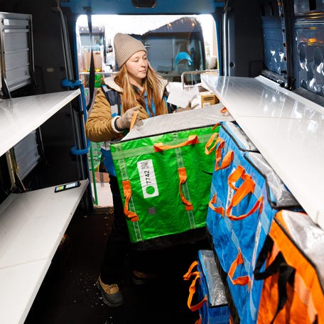 Ashton Ford loads her delivery vehicle with packages at Amazon's Elkhart Delivery Station on Dec. 1, 2025, in Elkhart, Indiana.