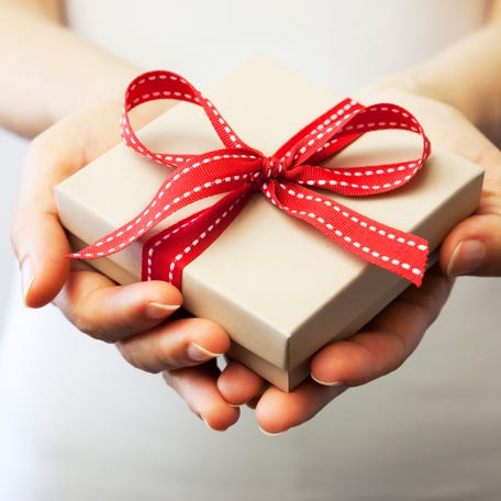 A person holding a gift box.