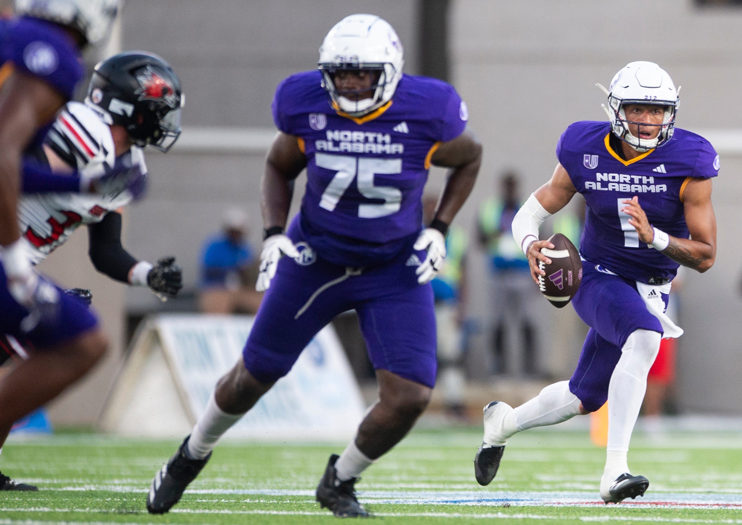 North Alabama Lions quarterback Ari Patu (1) roles out of the pocket as North Alabama Lions face off with Southeast Missouri State Redhawks during the FCS Kickoff game at Cramton Bowl in Montgomery, Ala., on Saturday, Aug. 24, 2024. North Alabama Lions leads Southeast Missouri State Redhawks 15-13 at halftime.