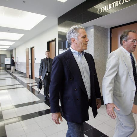 Jeffrey Epstein, left, enters a Palm Beach County courtroom on June 30, 2008 with attorney Guy Lewis.