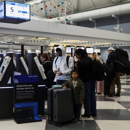Passengers prepare to board flights for the Thanksgiving holidays, at Chicago O'Hare International Airport in Chicago, Illinois, U.S., November 26, 2025.
