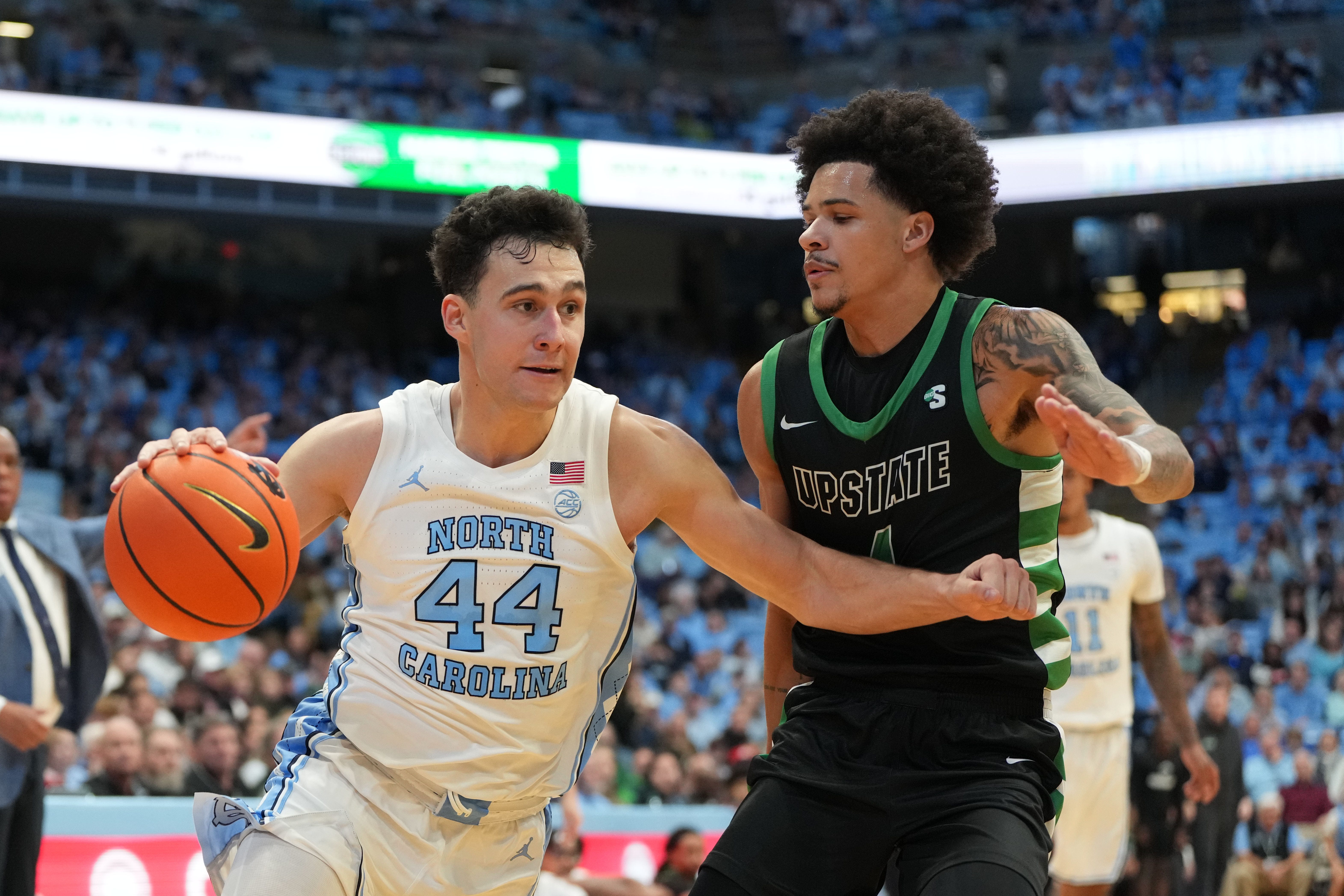 Dec 13, 2025; Chapel Hill, North Carolina, USA; North Carolina Tar Heels guard Luka Bogavac (44) dribbles as USC Upstate Spartans guard Carmelo Adkins (4) defends in the second half at Dean E. Smith Center. Mandatory Credit: Bob Donnan-Imagn Images