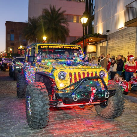 Decorated Jeeps move along River Street during the annual Savannah Lighted Christmas Parade on Saturday, December 13, 2025.
