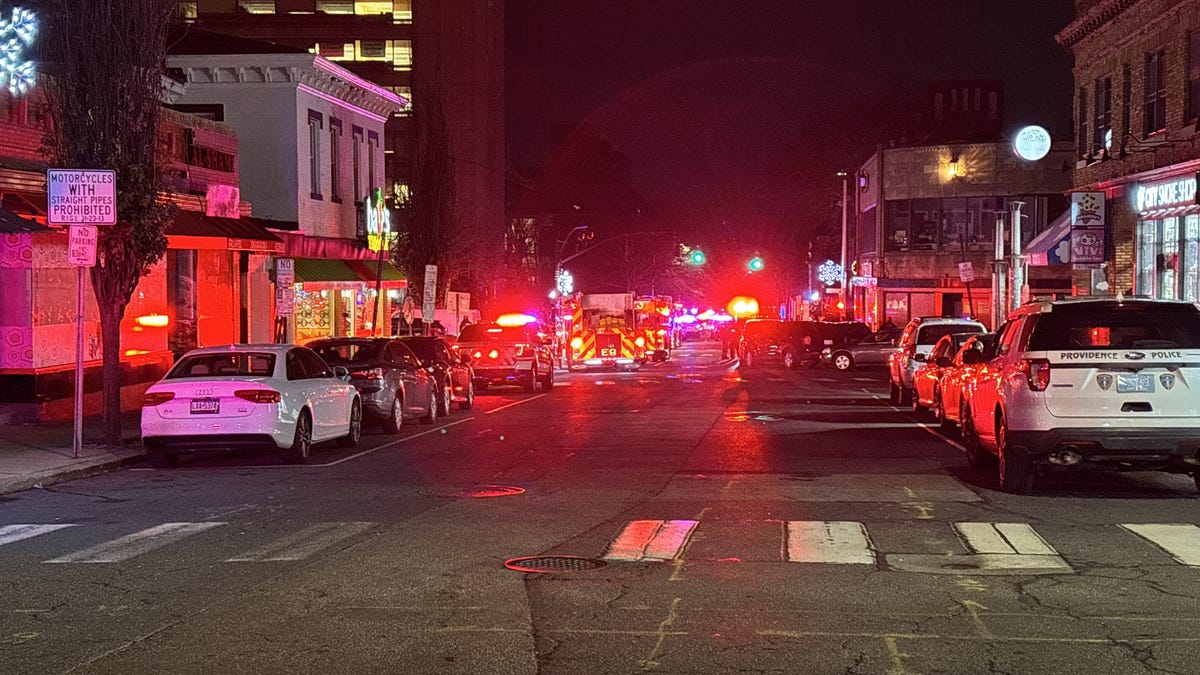 At Angel and Thayer, police rope off the scene as they continue to search for the suspect of a shooting at Brown University