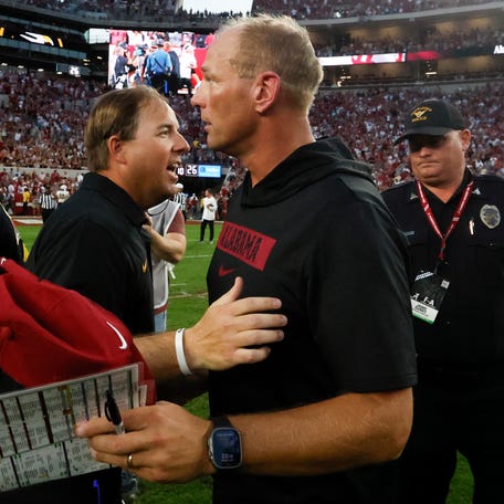 Oct 26, 2024; Tuscaloosa, Alabama, USA; Missouri Tigers head coach Eliah Drinkwitz (left) talks with Alabama Crimson Tide head coach Kalen DeBoer (right) after a game at Bryant-Denny Stadium. Mandatory Credit: Butch Dill-Imagn Images
