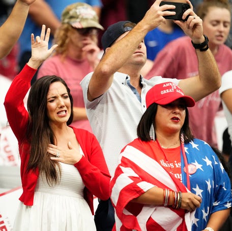 Participants worship during a memorial service honoring Charlie Kirk in Glendale, Arizona, on Sept. 21, 2025, after the conservative activist and founder of Turning Point USA was fatally shot.