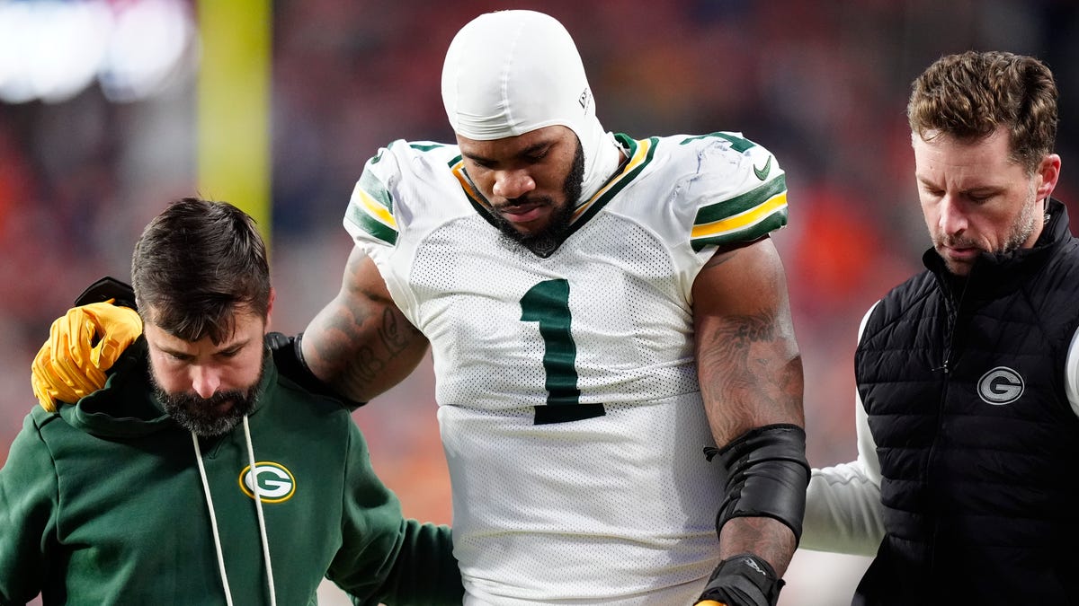 Dec 14, 2025; Denver, Colorado, USA; Green Bay Packers defensive end Micah Parsons (1) walks off the field with help from medical personnel following an injury during the third quarter against the Denver Broncos at Empower Field at Mile High. Mandatory Credit: Ron Chenoy-Imagn Images