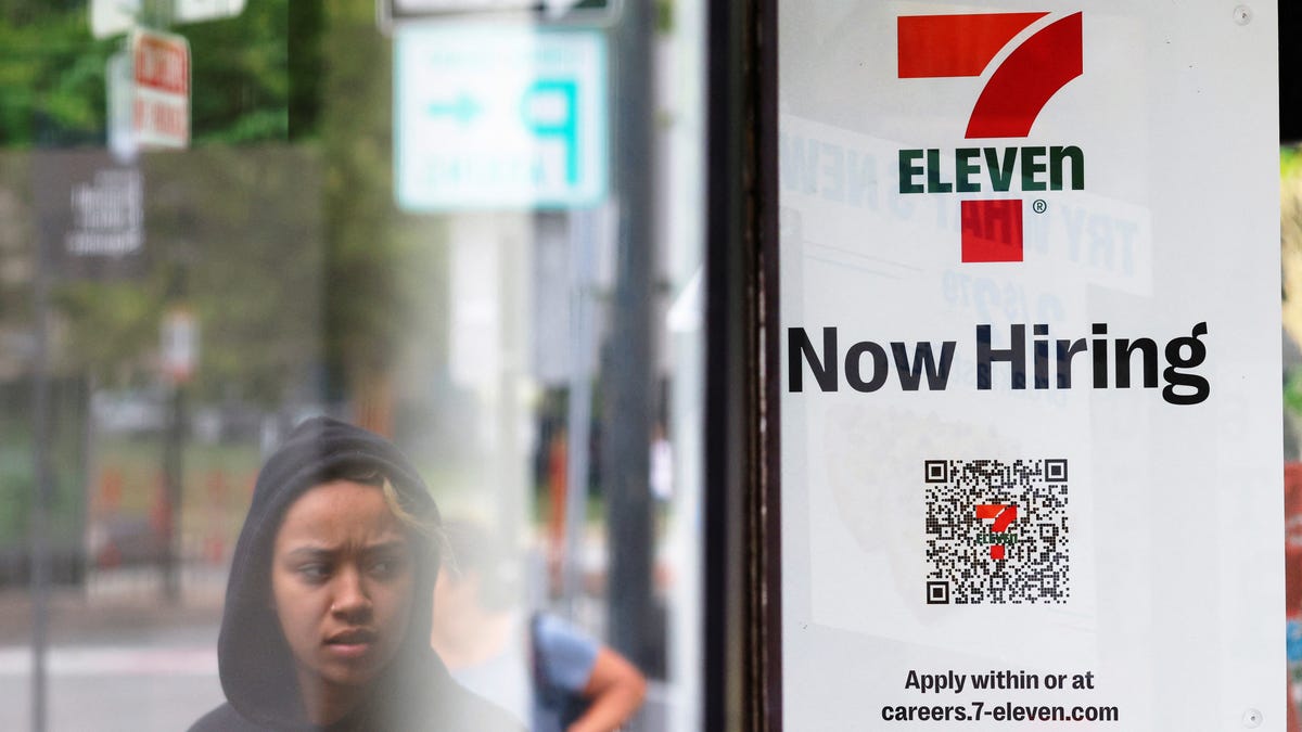 A 7-Eleven convenience store has a sign in the window reading "Now Hiring" in Cambridge, Massachusetts, U.S., July 8, 2022. REUTERS/Brian Snyder
