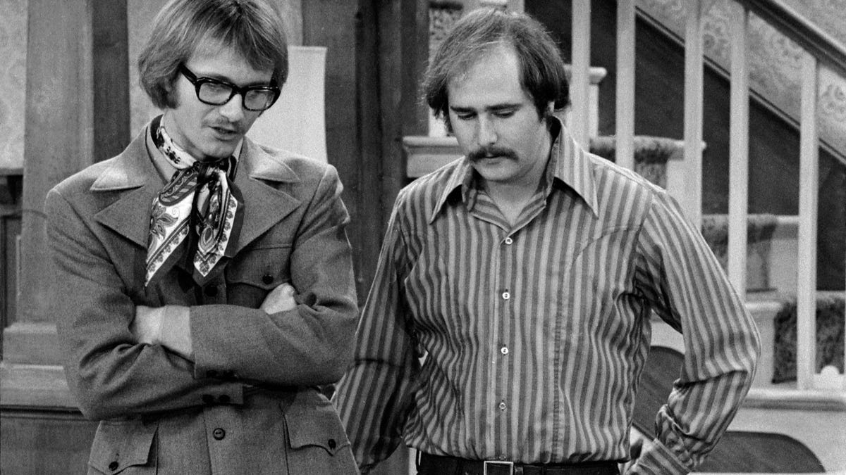 In the 1971 "All in the Family" episode "Judging Books by Covers," Anthony Geary, left, stars as Roger, alongside Rob Reiner as Michael Stivic and Carroll O'Connor as Archie Bunker.