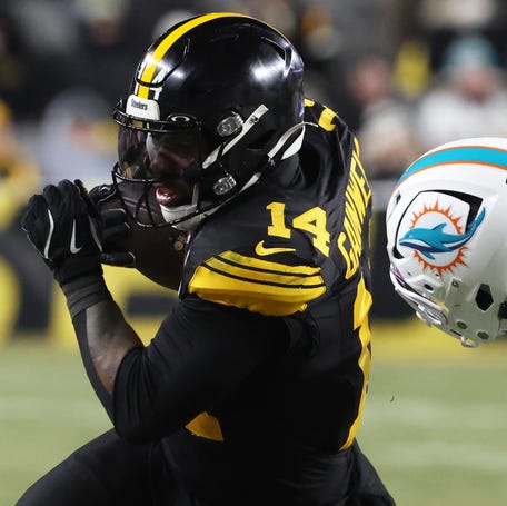Pittsburgh Steelers running back Kenneth Gainwell (14) runs with the ball while defended by Miami Dolphins cornerback Jack Jones (23) in the second quarter at Acrisure Stadium on Dec. 15, 2025.