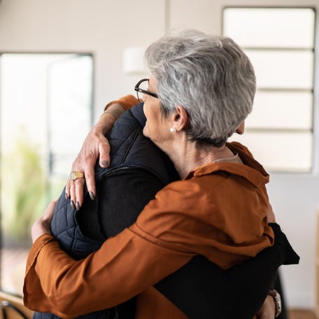 Mother and son embracing at home