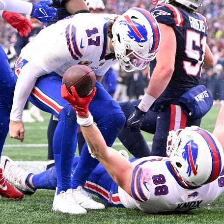 Buffalo Bills tight end Dawson Knox (88) celebrates with quarterback Josh Allen (17) after scoring a touchdown against the New England Patriots during the second half at Gillette Stadium on Sunday, Dec. 14, 2025, in Foxborough, Massachusetts.