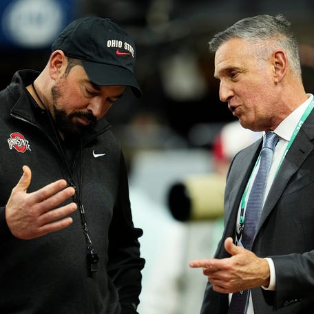 Ohio State Buckeyes head coach Ryan Day talks to Big Ten Conference commissioner Tony Petitti prior to the Big Ten Conference championship game against the Indiana Hoosiers at Lucas Oil Stadium in Indianapolis on Dec. 6, 2025. Ohio State lost 13-10.