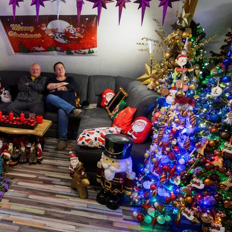 Susanne and Thomas Jeromin, the official world record holders recognized by the Record Institute Germany (RID) with 621 decorated Christmas trees in one home, pose for a photo in their living room in Rinteln, west of Hanover, Germany, December 4, 2025.