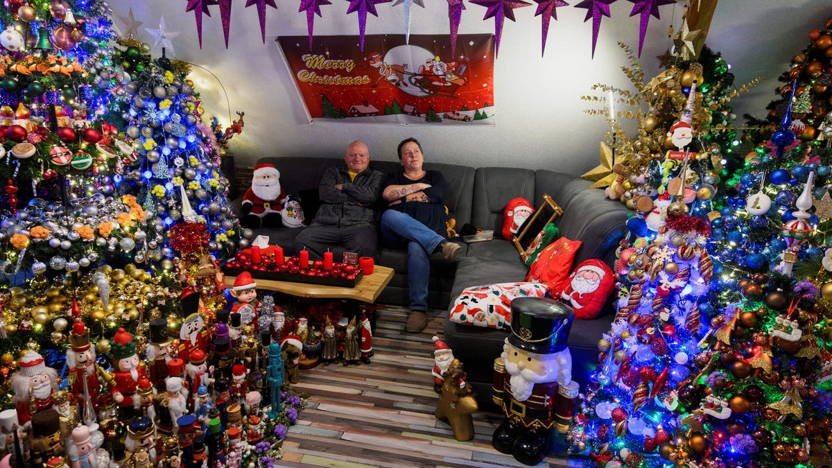 Susanne and Thomas Jeromin, the official world record holders recognized by the Record Institute Germany (RID) with 621 decorated Christmas trees in one home, pose for a photo in their living room in Rinteln, west of Hanover, Germany, December 4, 2025.