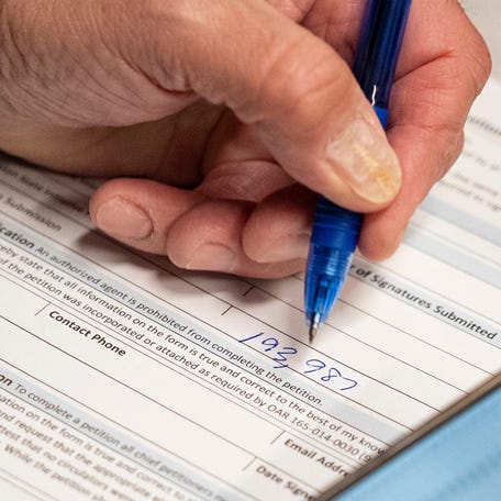 Rep. Ed Diehl, R-Stayton, writes how many signatures were submitted in a form at the Oregon Secretary of StateÃ•s office on Friday, Dec. 12, 2025, in Salem, Ore.