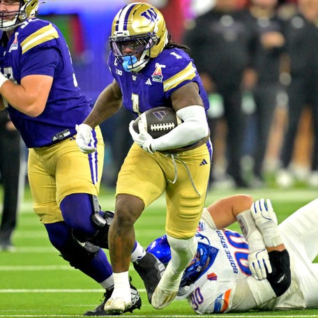 Washington running back Jonah Coleman (1) carries the ball against Boise State during the first half of the 2025 LA Bowl at SoFi Stadium.
