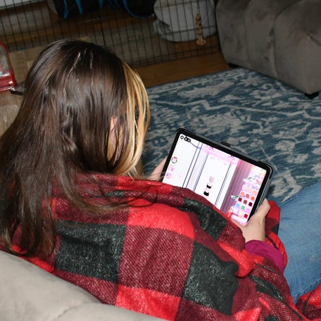 Amie's daughter used Roblox to make friends. A predator she met on the platform groomed her and later convinced her to send sexually explicit content off the app. She still experiences anxiety. Here, she holds her security blanket.