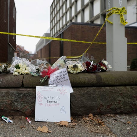 Flowers, signs and police tape at Brown University in Providence, Rhode Island, after a shooter killed two students and injured nine on Dec. 13, 2025. On Dec. 18, authorities discovered the body of 48-year-old Claudio Manuel Neves Valente in a New Hampshire self-storage unit. Neves Valente is the suspected gunman in the Brown shooting and another two days later that left an MIT professor dead.