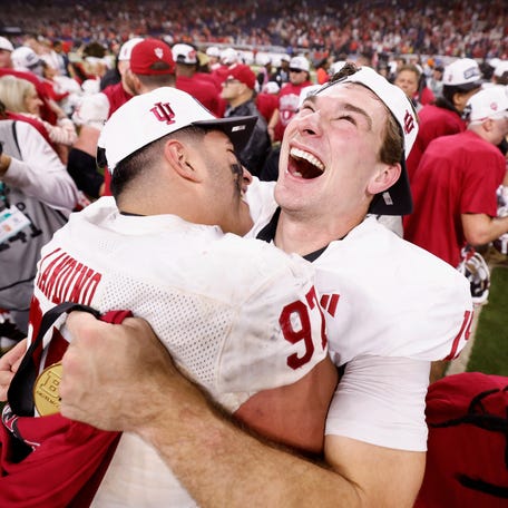 Mario Landino #97 and Fernando Mendoza #15 of the Indiana Hoosiers celebrate after defeating the Ohio State Buckeyes 13-10 in the 2025 Big Ten Football Championship at Lucas Oil Stadium on December 06, 2025 in Indianapolis, Indiana.