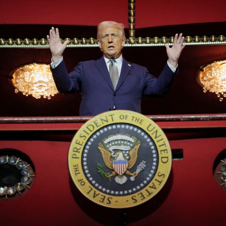 President Donald Trump gestures while he poses for a picture at the presidential box at the Kennedy Center, in Washington, D.C., U.S., March 17, 2025.