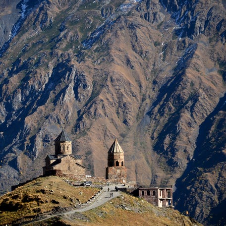 A picture shows 14th century Gergeti church in the village of Stepantsminda (former Kazbegi) close to Russian-Georgian border, some 160 km north of the capital Tbilisi. / AFP / KIRILL KUDRYAVTSEV (Photo credit should read KIRILL KUDRYAVTSEV/AFP via Getty Images)