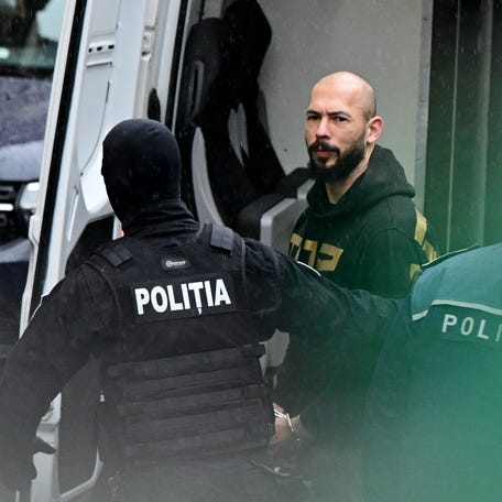 British-US former professional kickboxer and controversial influencer Andrew Tate is led by police officers to the Court of Appeal in Bucharest, Romania on March 12, 2024, following his and his brother's arrest over UK sex offence charges.