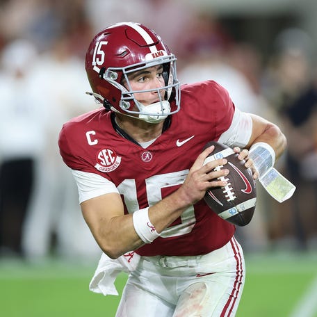 Ty Simpson #15 of the Alabama Crimson Tide rolls out of the pocket against the Tennessee Volunteers during the fourth quarter at Bryant-Denny Stadium on October 18, 2025 in Tuscaloosa, Alabama.