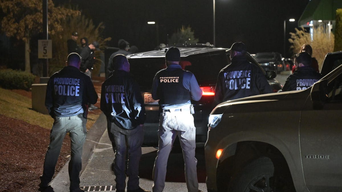 Police swarm a storage facility in Salem, New Hampshire on December 18, in connection with the shooting at Brown University