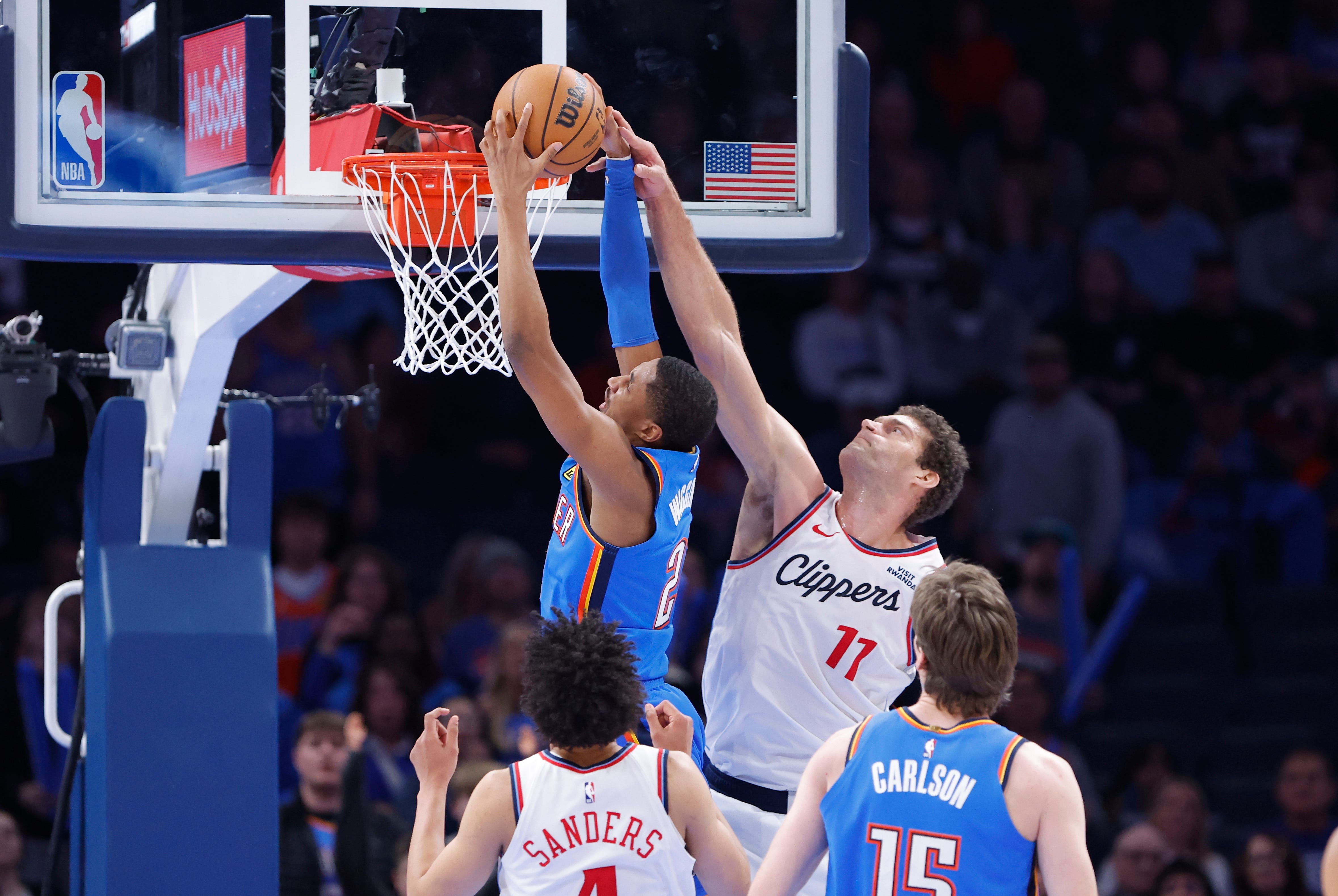 Dec 18, 2025; Oklahoma City, Oklahoma, USA; Los Angeles Clippers center Brook Lopez (11) fouls Oklahoma City Thunder guard Aaron Wiggins (21) as he goes up for a basket during the second half at Paycom Center. Mandatory Credit: Alonzo Adams-Imagn Images