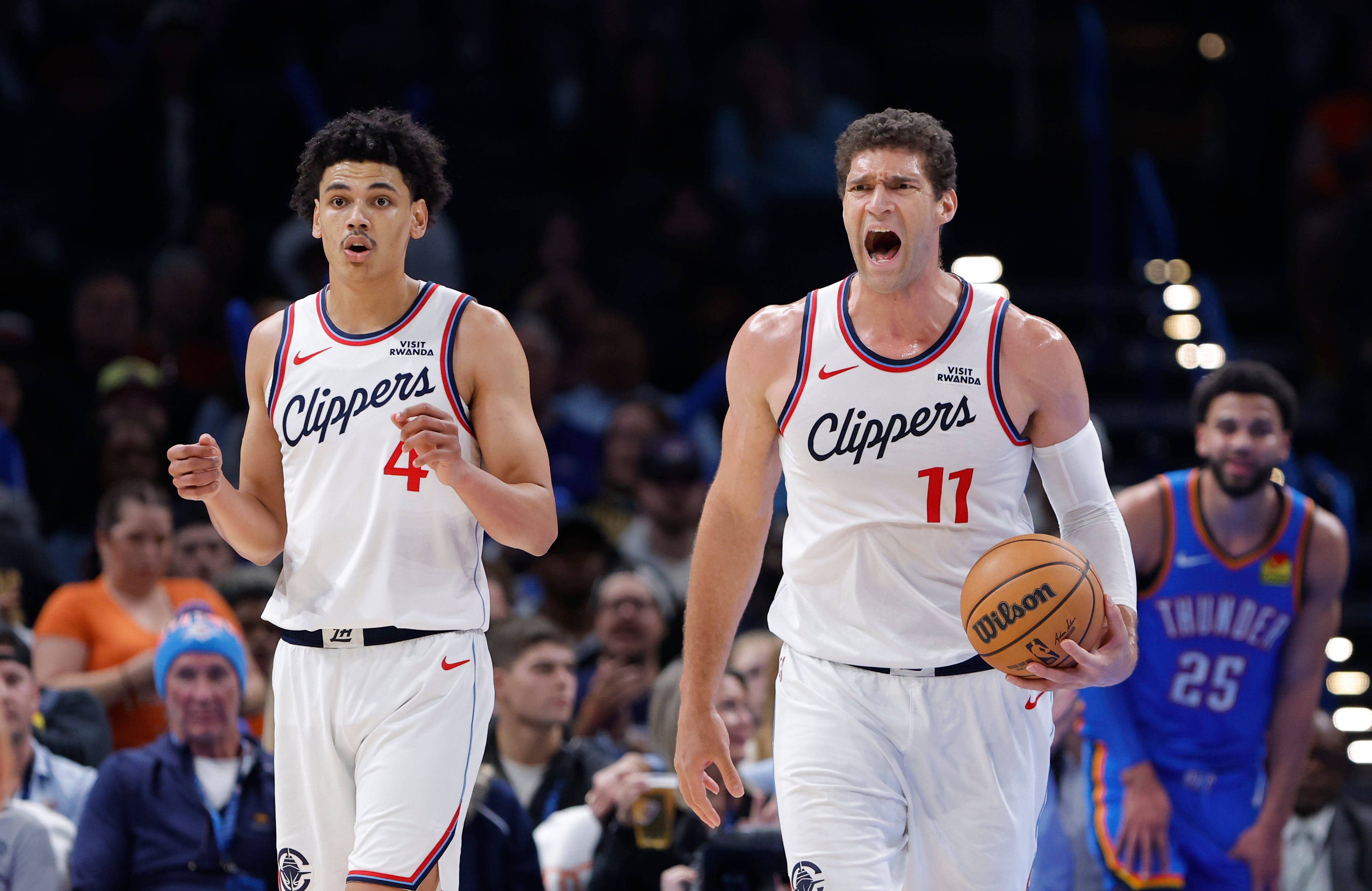 Dec 18, 2025; Oklahoma City, Oklahoma, USA; Los Angeles Clippers center Brook Lopez (11) and guard Kobe Sanders (4) react after a call following a play against the Oklahoma City Thunder the during the second half at Paycom Center. Mandatory Credit: Alonzo Adams-Imagn Images