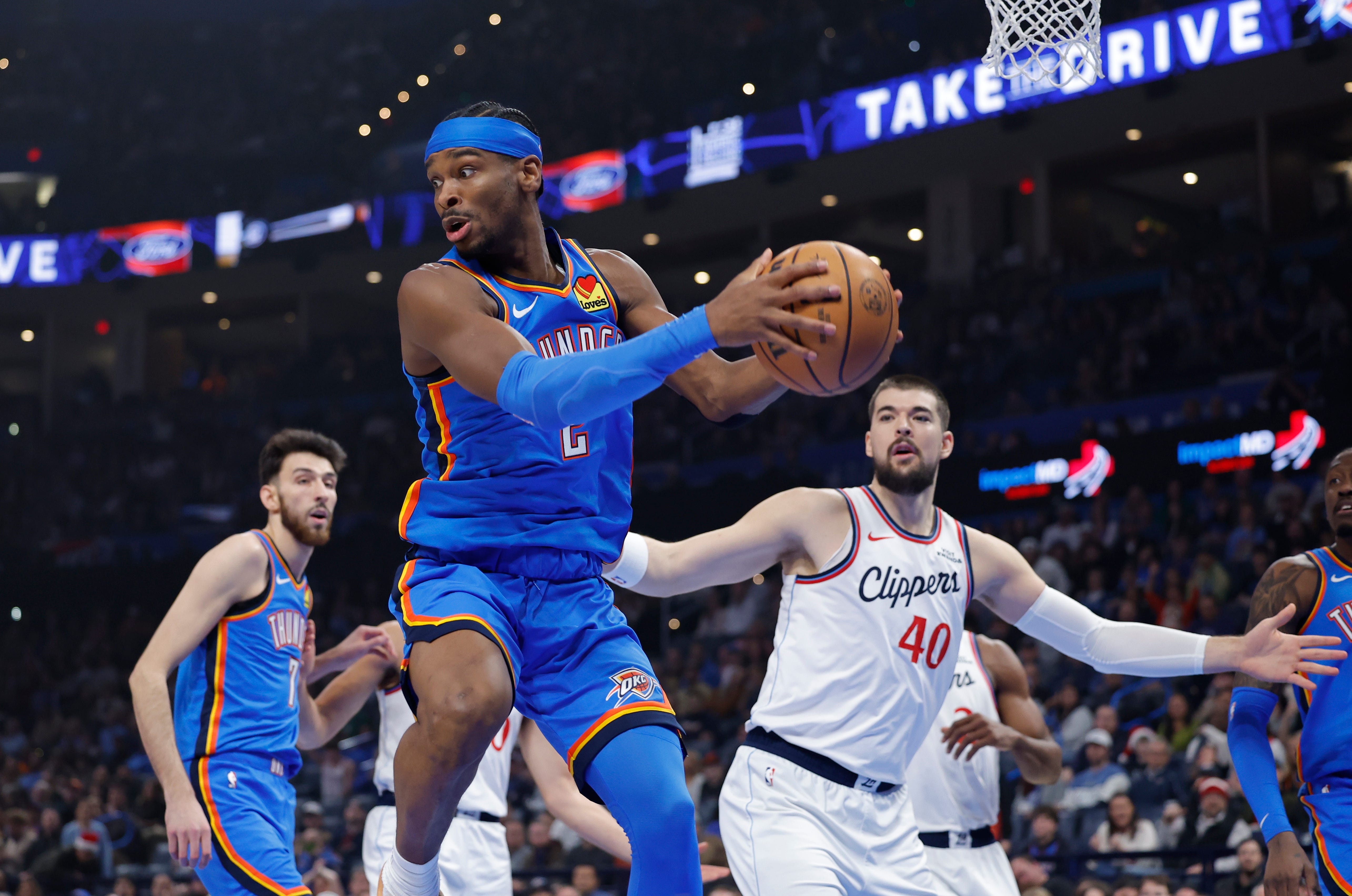 Dec 18, 2025; Oklahoma City, Oklahoma, USA;Oklahoma City Thunder guard Shai Gilgeous-Alexander (2) grabs a rebound after a shot by the Los Angeles Clippers during the first quarter at Paycom Center. Mandatory Credit: Alonzo Adams-Imagn Images
