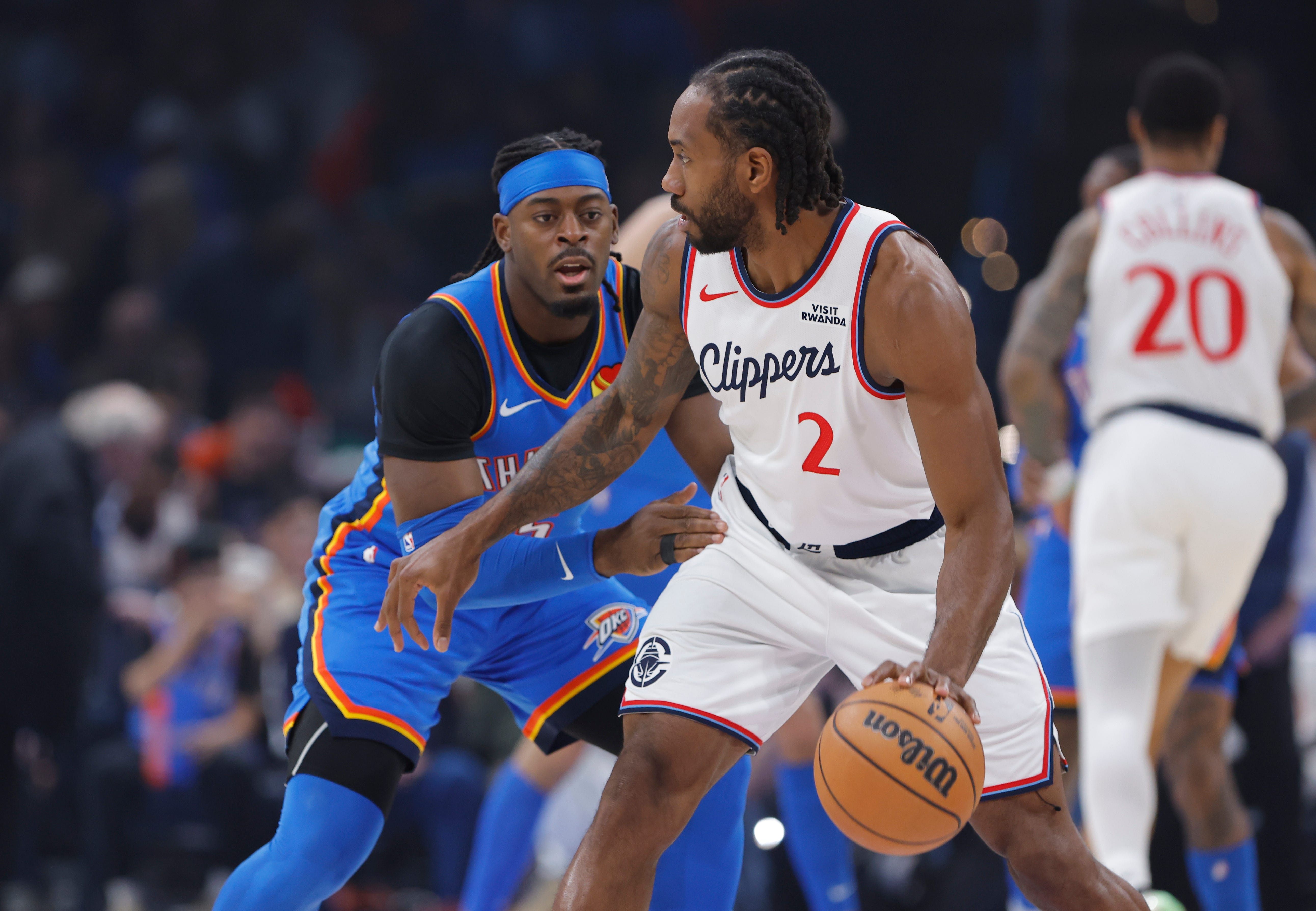 Dec 18, 2025; Oklahoma City, Oklahoma, USA; Los Angeles Clippers forward Kawhi Leonard (2) moves the ball against Oklahoma City Thunder guard Luguentz Dort (5) during the first quarter at Paycom Center. Mandatory Credit: Alonzo Adams-Imagn Images