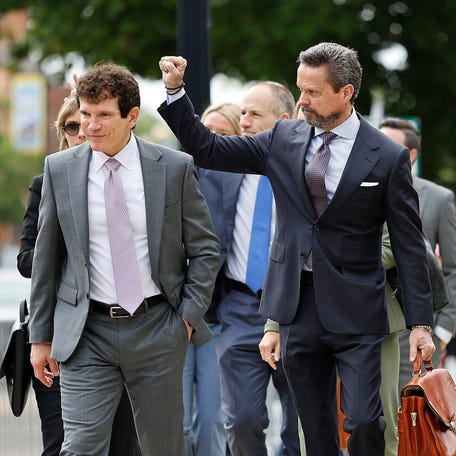 Karen Read's lawyer Alan Jackson signals to the crowd as the defense team walks to Norfolk Superior Court in Dedham, Massachusetts for a third day of jury deliberations and hundreds of supporters wait outside for any news on Tuesday, June 17, 2025.