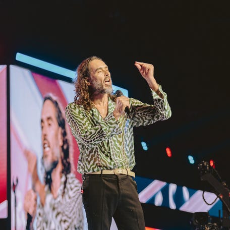 Russell Brand speaks during Turning Point's annual AmericaFest conference, in remembrance of late right-wing political activist Charlie Kirk, in Phoenix on Dec. 18, 2025.