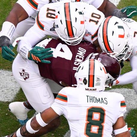 Texas A&M running back Rueben Owens II (4) is tackled by Miam defenders during the first round of the 2025 College Football Playoff at Kyle Field.