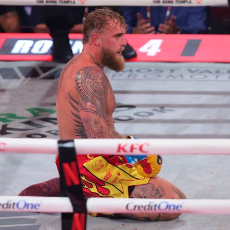 Jake Paul looks on from the canvas against Anthony Joshua during a heavyweight boxing bout at Kaseya Center.