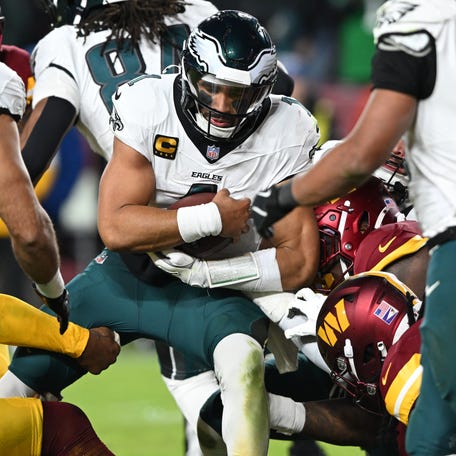 Jalen Hurts #1 of the Philadelphia Eagles runs the ball against the Washington Commanders in the third quarter at Northwest Stadium on December 20, 2025 in Landover, Maryland.