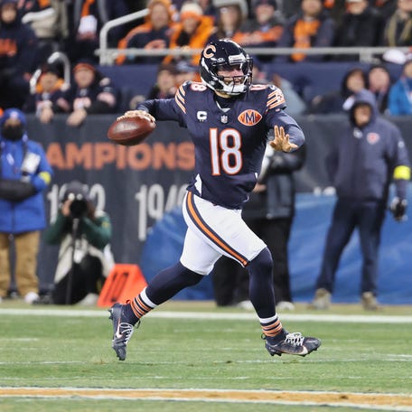 Dec 20, 2025; Chicago, Illinois, USA; Chicago Bears quarterback Caleb Williams (18) looks to throw a pass while running with the ball against the Green Bay Packers during the first quarter at Soldier Field. Mandatory Credit: Mike Dinovo-Imagn Images