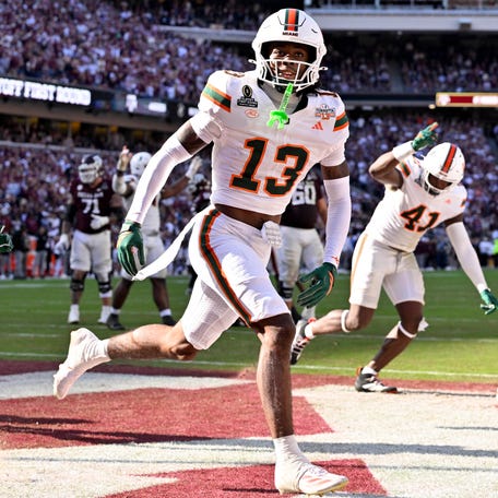 Miami defensive back Bryce Fitzgerald (13) celebrates after he intercepts a Texas A&M pass to clinch a win in the first round of the 2025 College Football Playoff at Kyle Field.