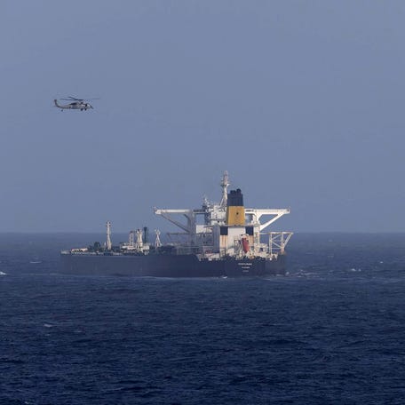 A U.S. military helicopter flies over the Panama-flagged Centuries, which was intercepted by the U.S. Coast Guard, days after President Donald Trump announced a "blockade" of all sanctioned oil tankers entering and leaving Venezuela, east of Barbados in the Caribbean Sea December 20, 2025